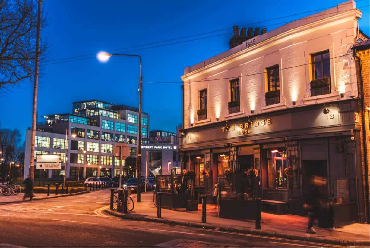 The Bridge pub in Ballsbridge at night with Herbert Park Hotel in the background