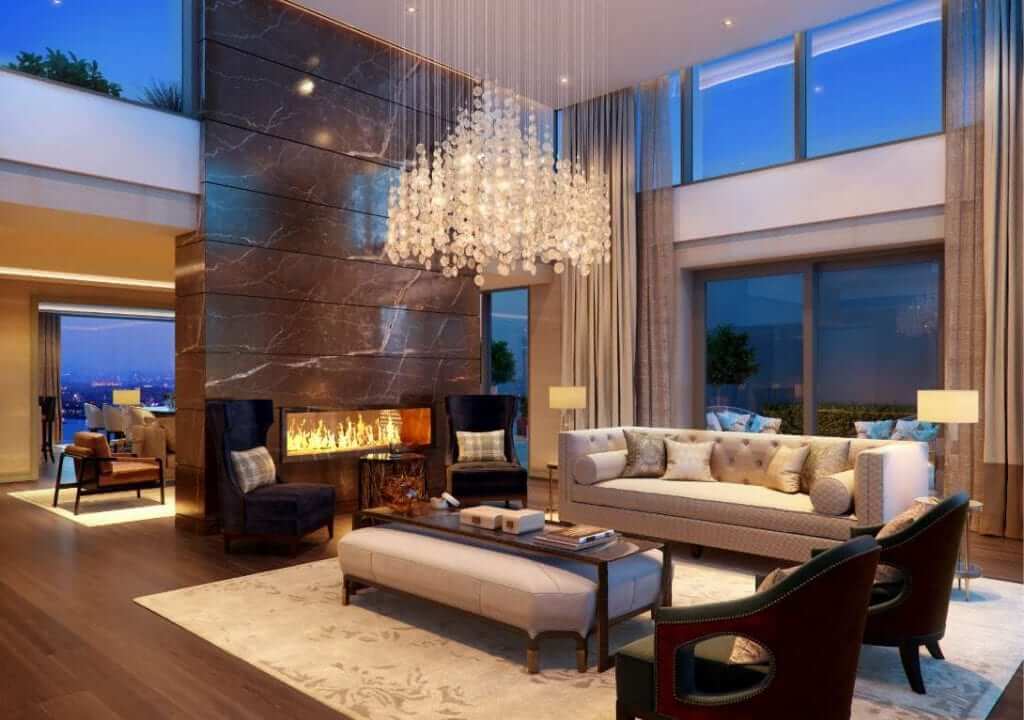 Double height living room with custom chandelier and feature fireplace with marble floor to ceiling surround