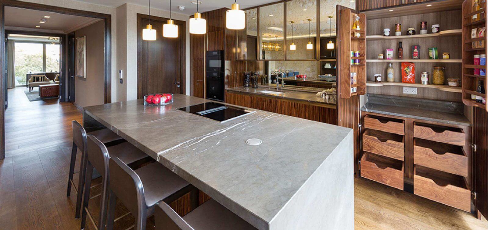 Handcrafted kitchen designed by Goddard Littlefair and handcrafted by O'Connors of Drumleck featuring double solid wood larder unit and Pietra marble counter top